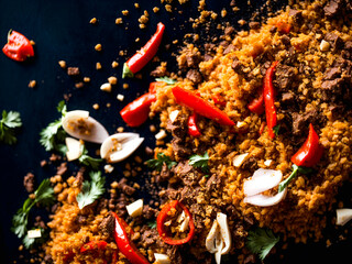 Explosion of different spices on a dark. Hot red pepper, garlic, different spices powder flying on a black background Motion freeze photo. Ai Generated