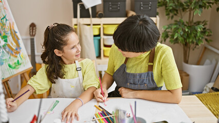 Fototapeta premium Artistic bonding, teacher and student together draw, speaking passionately at the art studio notebook session