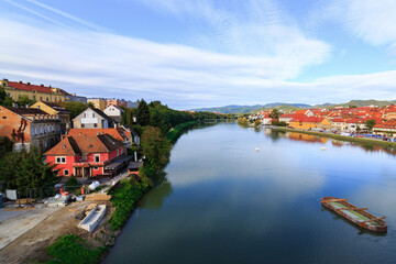 Buildings near the river Drava in Maribor city, Slovenia on a cold october morning. It was sunrise with a cloudy sky