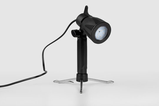a constant light source powered by an electric grid, a studio lamp for shooting objects, a lantern