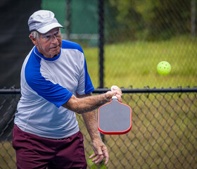 Male player applies undercut spin on pickleball during a tournament