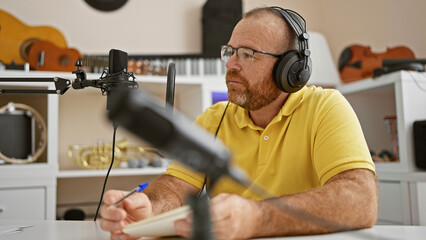 Caucasian man radio reporter working taking notes at radio studio