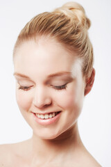 Obraz premium Portrait of happy woman, face or skincare for wellness with cosmetics, aesthetic or healthy glow. Dermatology, studio or confident female model with pride, smile or beauty results on white background