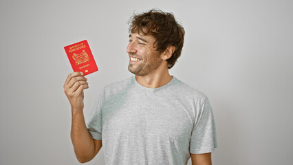 Beaming young man joyfully presents his pass, a singapore passport, confidently standing isolated...