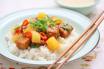 sweet and sour tempeh with pineapple chunks over rice