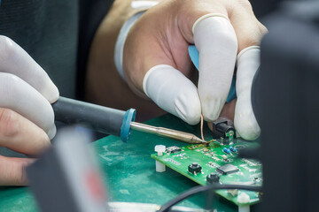 Close up scene the soldering operation by skill operator with rubber finger cot.