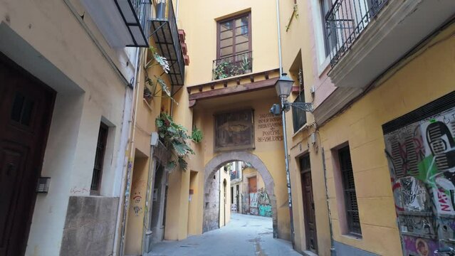 Quiet old-style Spanish street with portal and transitional gallery