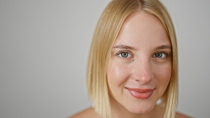 Young blonde woman smiling confident standing over isolated white background