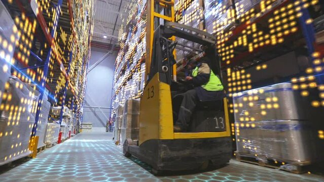 Modern forklift in a warehouse. Visualization of modern technologies in the warehouse of the factory. Forklift in a large modern warehouse with graphics
