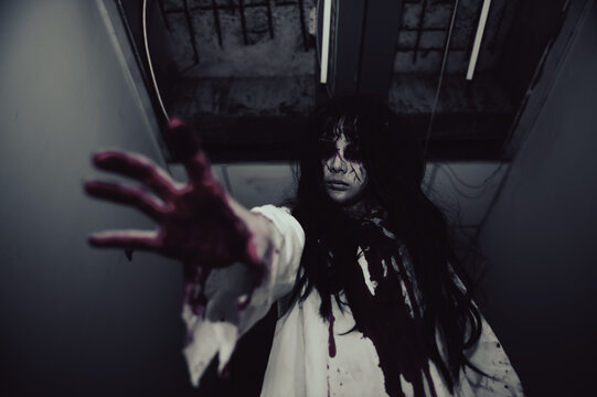 Portrait of asian woman make up ghost,Scary horror scene for background,Halloween festival concept,Ghost movies poster,angry spirit in the apartment