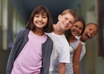Girl, portrait and friends in line at school with confidence and pride for learning, education or knowledge. Student, people and face with smile in building or hallway before class or ready to study