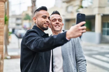 Fotobehang Two men couple smiling confident make selfie by smartphone at street © Krakenimages.com