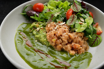 Salmon tartar with avocado and mixed greens