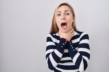 Young caucasian woman wearing casual navy sweater shouting and suffocate because painful strangle. health problem. asphyxiate and suicide concept.