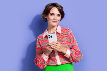 Photo portrait of lovely young lady hold telephone ecommerce wear trendy print garment isolated on violet color background