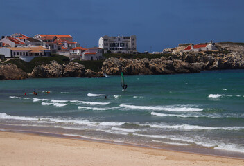 Watersports at the coast in front of the historic houses of peninsula Baleal (Peniche, Portugal)
