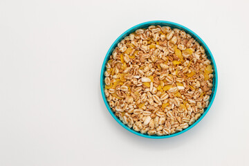 Bowl of puffed wheat and unsweetened corn. Vegan breakfast. Top view.

