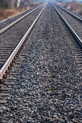 Fototapeta premium Parallel train tracks in a track bed