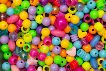 Colorful children's costume jewelry. Background of colored beads. Texture and macro image.