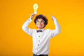 Child boy holding paper bulb. Success, motivation, winner, genius, idea concept