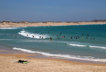 Fototapeta na wymiar Summer vibes - learning surfing at the Atlantic coast (beach Baleal, Peniche, Portugal)
