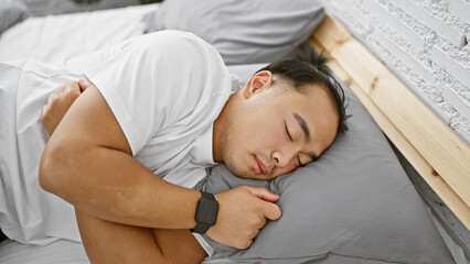 Handsome young chinese man in pajamas, comfortably asleep, tired yet relaxed, lying in the cozy...