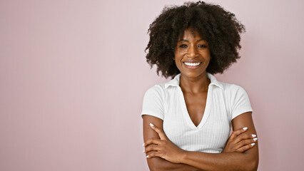 African american woman smiling confident standing with arms crossed gesture over isolated pink background