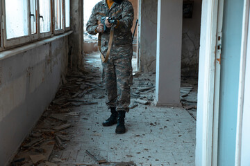 Warrior Amidst Ruins: Soldier with Military Rifle in Dilapidated Building