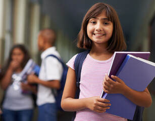 Girl, portrait and happy in corridor of school with backpack or books for learning, education or knowledge. Student, person and face with smile in building or hallway before class or ready to study