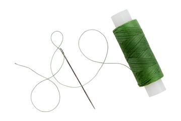 Old spool of thread and needle on a white background. Sewing accessories - obrazy, fototapety, plakaty