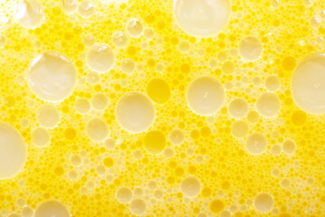 Texture of fat or oil with yellow bubbles. Background of fat bubbles