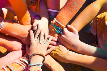 Fototapeta premium Friends putting their hands together in a sign of unity and teamwork