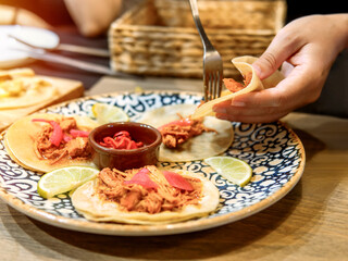 Enjoying Fresh Tacos with Pulled Chicken and Pickled Onions