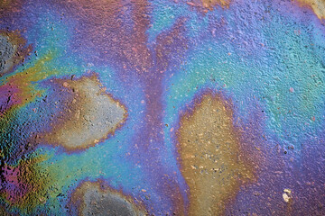 Oil stain or gasoline caused by a leak under a car.