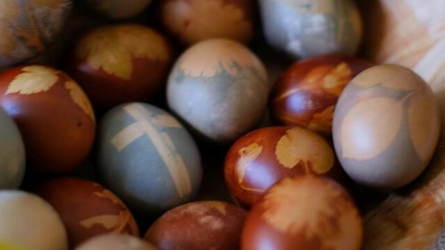 Easter eggs on a table closeup, decorated with floral motifs and painted with organic colors and spring flowers of a dandelion
