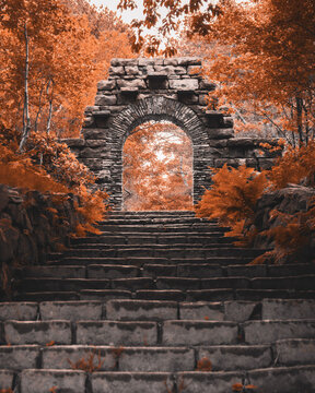 Old stone archway ruin with autumn trees, countryside forest ruins, historic England, magical fairytale, Rivington Pike