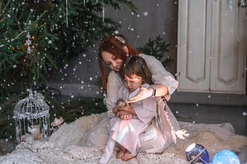 mother and son in white with wings in the Christmas studio