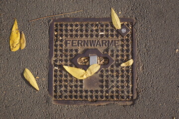 On the sidewalk, you can see the cover of a shut-off valve for district heating.