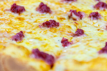 Close-up of a delicious Italian pizza with cheese and sausages (Merguez).