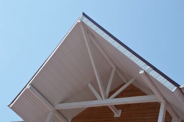 Wooden house, upper part, during construction, roof. Close-up part of the roof ridge of the house...