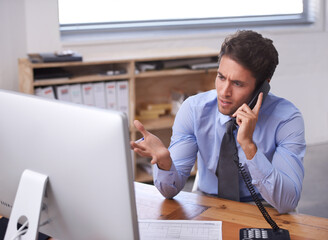 Business man, phone call and stress on landline in workplace, contact and consulting or networking. Male professional, frustrated and communication or discussion, technology and confusion for info