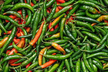 Harvest green and red chilies. Green and red chilies in traditional market. Green and red chilies fullframe.. Horizontal mode.