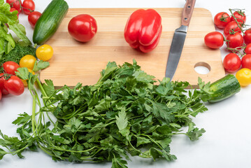 Kitchen knife and vegetables preparing to prepare vegetable salad.