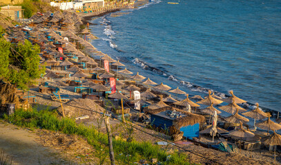 currilave beach shoreline with hotels in Durres, Albania during sunset