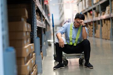 Asian warehouse worker who is unhappy after being fired from his job Unemployed people fail,...