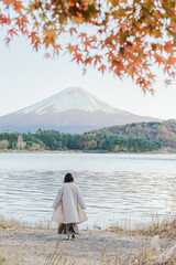person on the lake with fuji mountain 