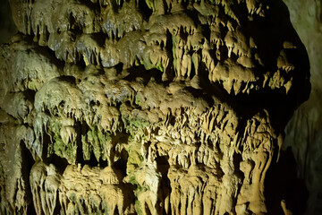 The cave is karst, amazing view of stalactites and stalagnites illuminated by bright light, a beautiful natural attraction in a tourist place.