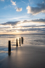 This serene image encapsulates the fleeting moments of twilight on a coastal landscape. Old wooden...