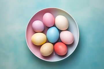 Easter eggs in a bowl on a light blue background