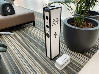 Mobile phone charging point, power supply for gadgets, bollard with sockets for USB cable. - obrazy, fototapety, plakaty